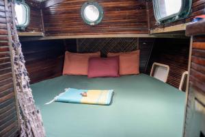 a small bed in the back of an rv at San Blas Sailing Experience With Us! in El Porvenir