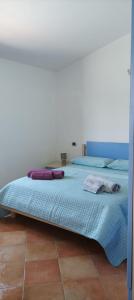 a bed in a room with two pillows on it at Villa Gallura Dream with private pool and sea view in Tanaunella
