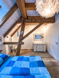 a bedroom with a blue bed and a dresser at Storchenhof Teningen in Teningen +132 photos