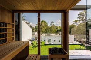 a view from the living room of a house with sliding glass doors at Villa Bauhaus Wellness Apartman in Siófok