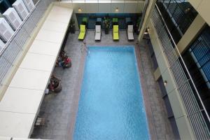 an overhead view of a swimming pool in a building at Hotel La Falaise Yaounde in Yaoundé