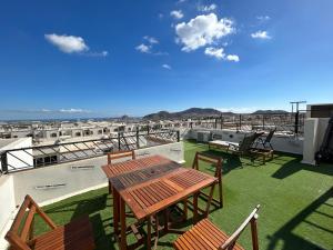 patio ze stołem i krzesłami na dachu w obiekcie Apartment jacuzzi Ocean view w mieście Cabo San Lucas