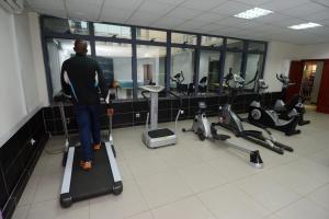 a man standing on a treadmill in a gym at Hotel La Falaise Yaounde in Yaoundé