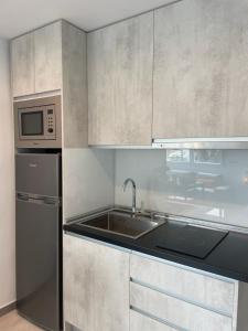 a kitchen with a sink and a microwave at Allegra Suite in Málaga