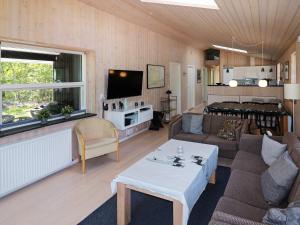 a living room with a couch and a table at Luxury Spa Retreat by Sea - By Traum Ferienwohnungen in Helberskov