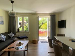 a living room with a couch and a table at Apartment II Am Jakobsweg in Erfurt