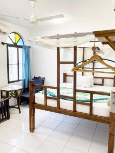 a bedroom with two bunk beds in a room at Garden Lodge in Zanzibar City