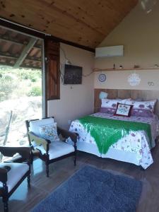 Postel nebo postele na pokoji v ubytování Chalé Mirante da Pedra