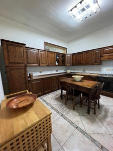 a kitchen with wooden cabinets and a wooden table at Casa Nonna Rusell in Naples