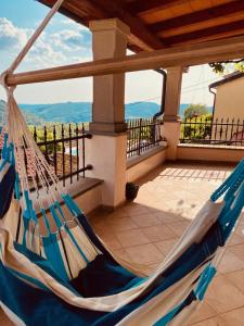 a hammock on a porch with a view at Istrian house Casa del nonno in Šmarje