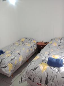two beds sitting next to each other in a room at Departamento el estadio in Santiago del Estero