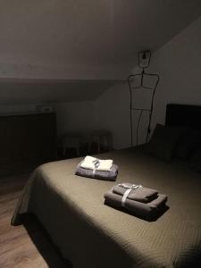 a bedroom with a bed with two towels on it at palalain appartement in Tarbes