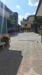 a brick courtyard with a bench and a building at Vitiello Maria's home in Pompei