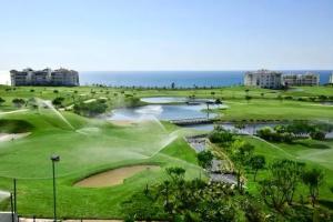 an aerial view of a golf course at the ocean at Prestigieux Appartement à Marina Assilah Golf in Asilah