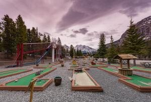 a playground with a bunch of play equipment at David Thompson Resort in Cline River
