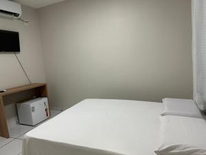 Una cama o camas en una habitación de Pousada Central dos Lençóis