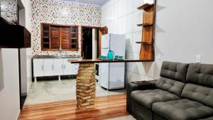 a kitchen with a table in the middle of a room at Casa temporada Flor de pitanga in Cavalcante +8 photos