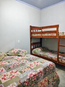 Postel nebo postele na pokoji v ubytování Casa temporada Flor de pitanga