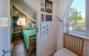 a small bedroom with a bed in a tiny house at Stunning Apartment In Bohus-malmn With Wifi And 3 Bedrooms in Malmön