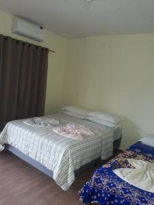 Una cama o camas en una habitación de Pousada do Dedé 51 fotos más