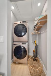 a washer and dryer in a laundry room at Luxury Villa 3 Blocks from the Beach with a Pool, Fire Pit and Outdoor Oasis in Cape Canaveral