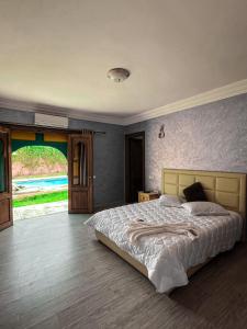 sypialnia z dużym łóżkiem i dużym oknem w obiekcie VILLA TAZARZIT w Marakeszu