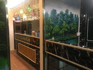 a restaurant with a painting on the wall in a room at Golden Thai binh Hotel in Thái Bình