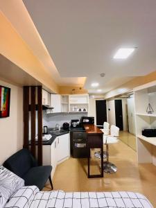 a kitchen and living room with a couch and a table at D Peaceful and Comfortable Room in Iloilo City +16 photos