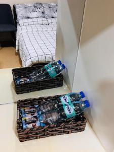 two baskets filled with water bottles sitting on a counter at D Peaceful and Comfortable Room in Iloilo City