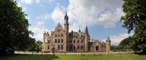 an old building with turrets on top of it at City Apartments Antwerpen in Antwerp