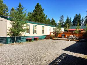 a house with a gravel driveway in front of it at Alpine #3 in West Yellowstone