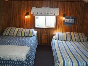 A bed or beds in a room at Sleeping Bear Riverside Cabins - Cabin #1