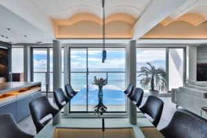 a dining room with a view of the ocean at 3rd House Inamuragasaki in Kamakura