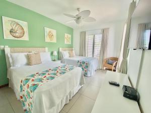 a hotel room with two beds and a table at Stunning Beachfront Condo With Private Beach, Las Terrenas-el Limn in El Limón