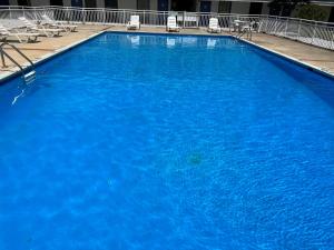 una gran piscina azul con sillas en un hotel en The Nest Hotel Suffolk, en Suffolk