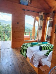 a bedroom with a large bed in a log cabin at Green Nature Paradise Ella in Ella