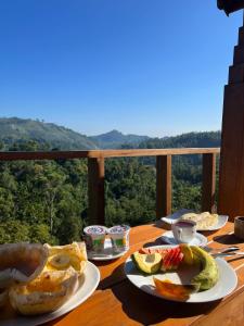 een tafel met borden eten op een tafel met uitzicht bij Green Nature Paradise Ella in Ella