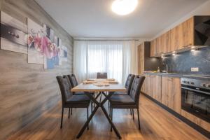 a dining room with a table and chairs in a kitchen at Pension Steinadler in Neustift im Stubaital