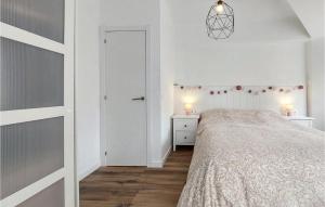 a white bedroom with a bed and two night stands at Nice Apartment In Castell De La Plana With Wifi And 3 Bedrooms in Castellón de la Plana