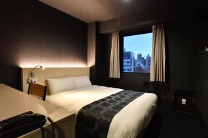 Postel nebo postele na pokoji v ubytování FL Hotel Dotonbori