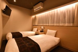 Postel nebo postele na pokoji v ubytování FL Hotel Dotonbori