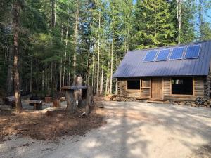 a cabin with solar panels on the side of it at Mini Moo-light Cabin in Clearwater