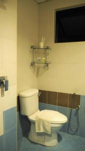 a bathroom with a toilet and a window and a towel at WTC Hotel, Kuala Lumpur - Formerly Leo Palace Hotel Classic Wing in Kuala Lumpur +64 photos