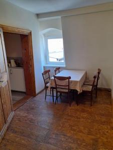 a dining room with a table and chairs and a window at Sieraków - Kraina 100 Jezior in Sieraków +16 photos