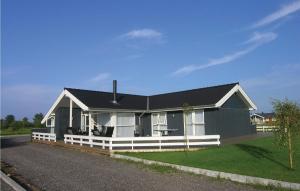 a black and white house with a porch at Beautiful Home In Otterup With 4 Bedrooms, Sauna And Wifi in Otterup