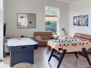 a living room with a large table in the middle of a room at Holiday home Væggerløse CCXIII in Bøtø By