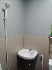 a bathroom with a sink and a shower at Z and J Transient House in Butuan