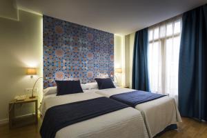 Posteľ alebo postele v izbe v ubytovaní Hotel Comfort Dauro 2