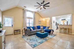 a living room with a blue couch and a ceiling fan at Pet Friendly Home by Katy in Houston