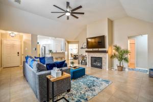 a living room with a blue couch and a fireplace at Pet Friendly Home by Katy in Houston
